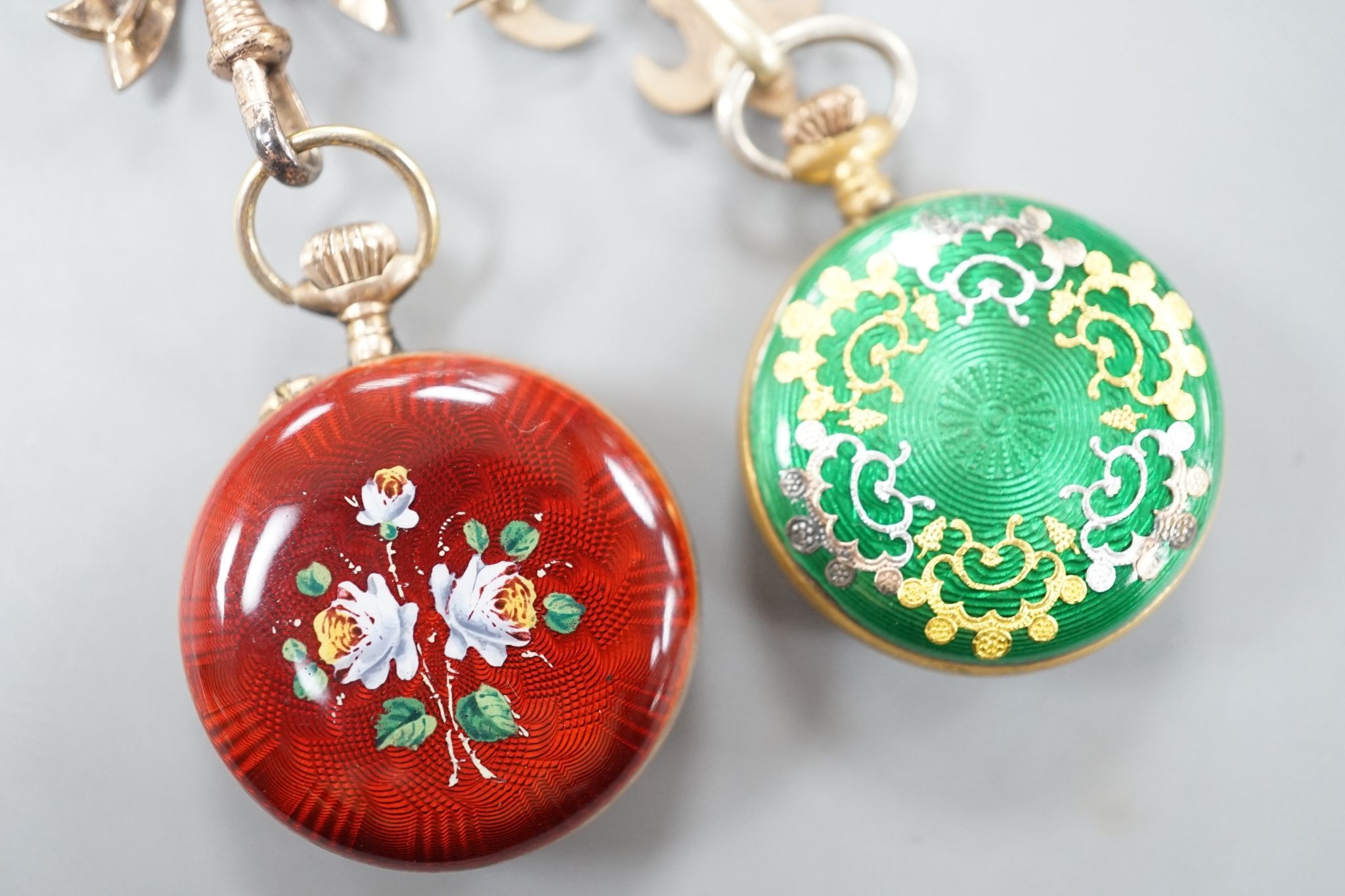 Two lady's early 20th century gilt metal and enamelled fob watches, on enamelled suspension brooches.